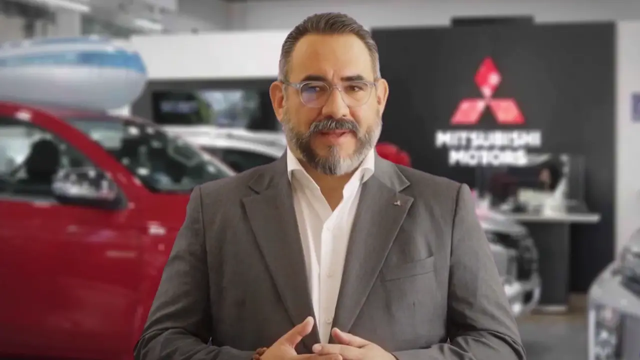 The CEO of Mitsubishi Motors Mexico speaking to camera in a dealership
